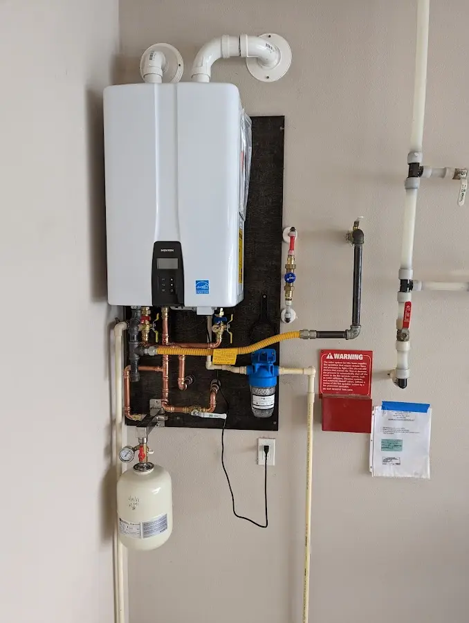 Professional plumber installing copper piping in a Brandenburg home